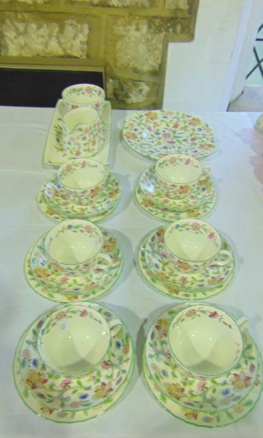 A collection of Minton Haddon Hall pattern tea wares comprising a cake plate, milk jug, sugar