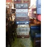 A collection of nine vintage suitcases including a vellum example