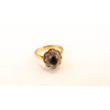 A sapphire and diamond ring, centred with an oval mixed-cut sapphire, the bezel highlighted with