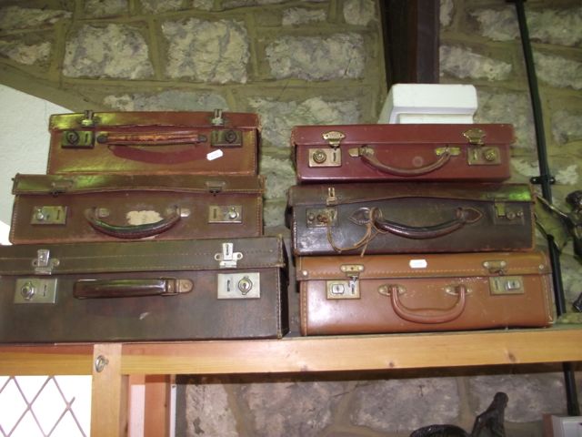 Six various stitched leather and simulated leather vintage briefcases, all with dual lever locks and