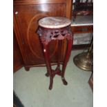 A Chinese hardwood jardiniere stand with marble top and four brass wall lights