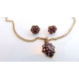 A gem-set pendant, set with untested garnets, in 9ct gold, on a 9ct gold chain; a pair of untested
