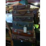 A tower of six small vintage suitcases in leather