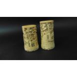 A pair of 19th century Chinese ivory vases with extensive carved and pierced detail with