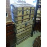 Three vintage travelling trunks in green canvas, timber overlaid with brass fittings and a vintage