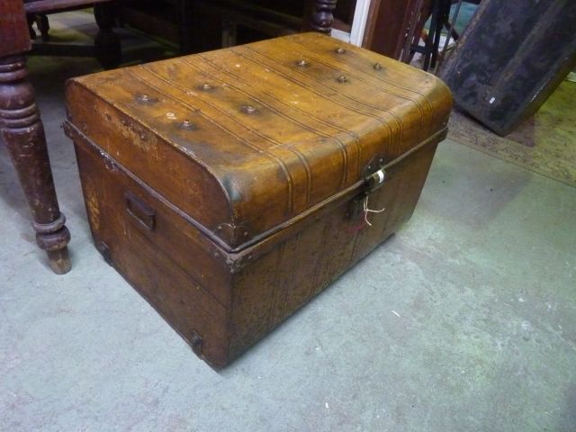 A vintage tin trunk with original simulated timber paintwork