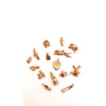 A miscellaneous collection of charms, including two 14ct gold charms, 1.8g in total, twelve 9ct gold