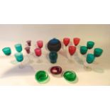 A selection of small coloured drinking glasses to include a trio with cranberry bowls and