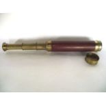 A late 19th/early 20th century brass three drawer telescope with timber casing and brass lens cap,