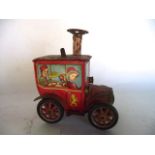 A 20th century Japanese wind-up tin plated toy in the form of a circus car, 13 cm tall x 10 cm