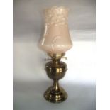 A brass oil lamp with Duplex burner and pale pink opaque pressed shade with moulded floral