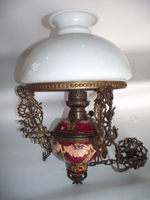 An electronic ceiling light (converted) with central ceramic fount with foliate detail and extensive