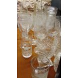 Five wine glasses with etched fruiting vine detail, a pair of cut glass beakers raised on square cut