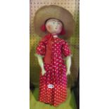 An antique Folk Art doll of timber construction with painted face and with hinged jointed limbs,