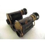 A pair of early 20th century leather clad German field binoculars, indistinctly stamped N 6499, also