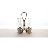 A WMF two-divisional silver-plated bottle cruet with stepped embossed detail, accomodating a pair of