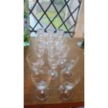 A selection of small etched drinking glasses to include four with etched script to bowls to