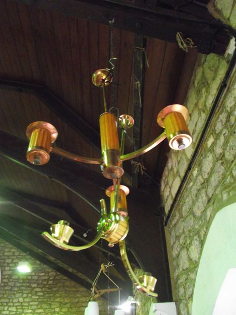 A three branch ceiling light, principally in copper in the Art Deco style, together with a similar