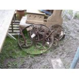 Seven vintage small cast iron implement wheels including two pairs, together with a further cast