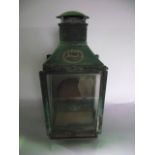 A 19th century wall hanging oil burning lantern set within a copper housing with three glazed