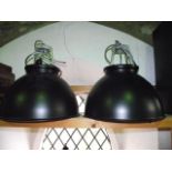 A pair of contemporary industrial ceiling light units, the metallic domed shades with blackened