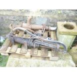 Two reclaimed cast iron hand operated water pumps of varying design