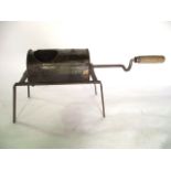 A vintage ironwork hand turned coffee roaster of cylindrical form, the aperture with sliding