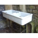 A reclaimed two divisional white glazed stoneware butlers sink