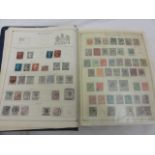 The International Postage Stamp Album containing an interesting worldwide collection of stamps,