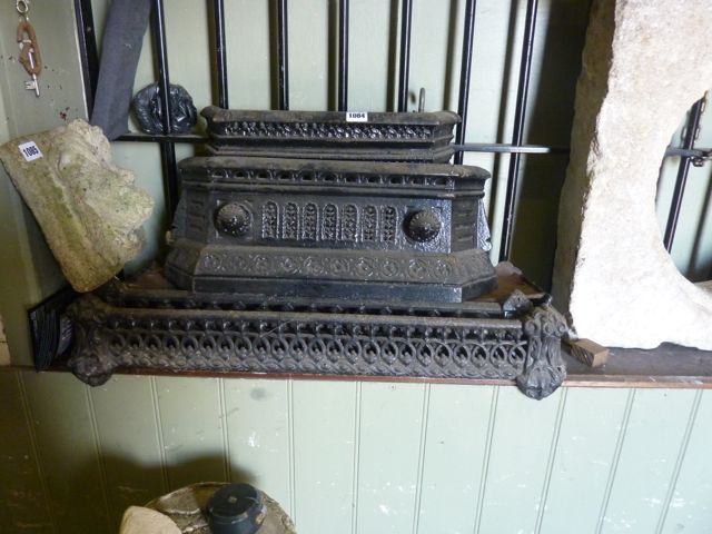 Two small Victorian cast iron fenders with pierced detail, together with two further Victorian