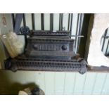 Two small Victorian cast iron fenders with pierced detail, together with two further Victorian