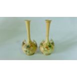 A pair of Royal Worcester blush ivory vases with globular bodies and slender drawn necks with ribbed