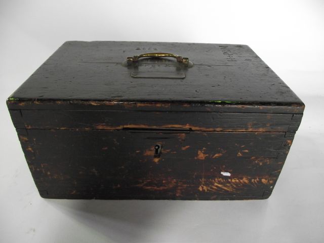 A rustic 19th century pine box of rectangular form, the hinged lid bearing a looping brass handle