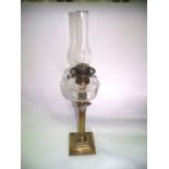 A good quality Victorian brass oil burning lamp raised on a Corinthian column stand, set before a