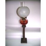 A Victorian oil burning lamp with brass base in the form of a fluted Corinthian column, raised on