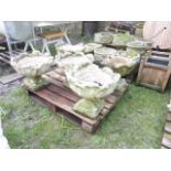 A set of five cast composition stone garden planters with squat foliate bowls and pedestal bases,