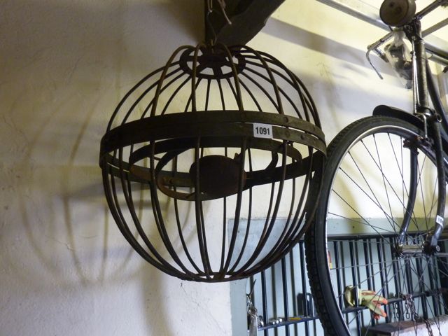 An antique style gimbal ships light encased in a melon shaped basket