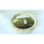 A 19th century mirror frame of oval form in the Belleek manner with ivory coloured glaze and