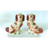 A pair of 19th century Staffordshire spaniels with red painted patches, 33 cm tall approx