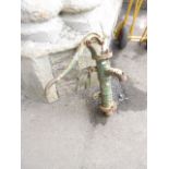 A small vintage reclaimed cast iron hand operated water pump