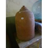 A weathered terracotta rhubarb forcer of squat cylindrical form (complete with cap)