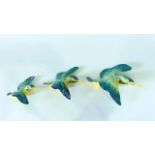 A set of three Beswick wall plaques in the form of flying kingfishers, with printed and impressed