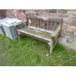 A weathered teakwood two seat garden bench with slatted seat and back, 128 cm long approx