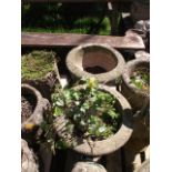 Two pairs of weathered cast composition stone garden planters of varying design, one pair with