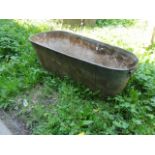 A vintage galvanised bath of tapered form