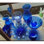 A selection of blue glass wares to include two Dartington vases with wrythen moulded finish, one