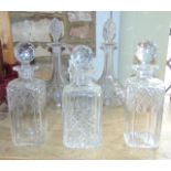 A good quality pair of tall cased decanters with diamond and fan cut detail set beneath cut