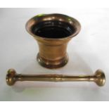 A 19th century brass pestle and mortar of usual form