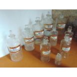 A selection of ten antique chemist bottles, all with tablet shaped stoppers, nine bearing content