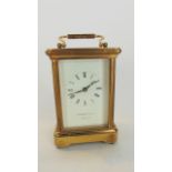 A brass carriage clock with 8 day timepiece, the dial marked Garrard & Co